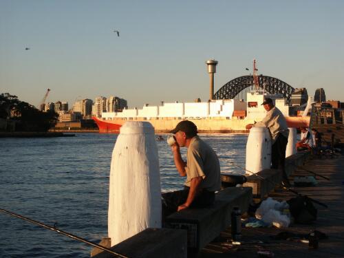 Fishermen on the boardwalk at Pyrmont, Sydney Harbour Bridge in the background [picture] / Patricia Baillie