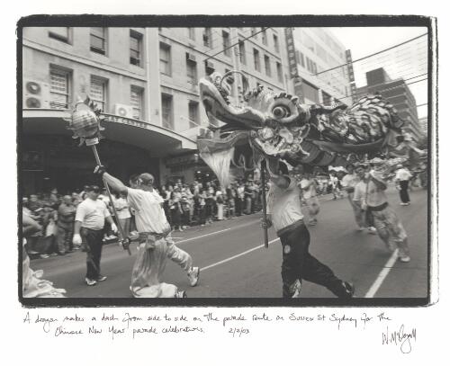 A dragon makes a dash from side to side on the parade route on Sussex St. [i.e. Street] Sydney for the Chinese New Year parade celebrations, 2 February 2003 [picture] / Wendy McDougall