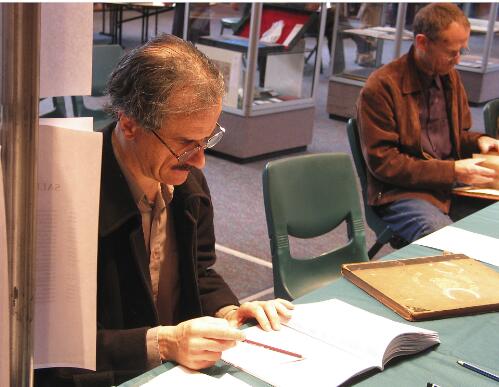 Peter Arnold, Melbourne antiquarian book dealer, examines a lot, Australian Book Auctions, 24-25 February 2004 [picture] / Francis Reiss