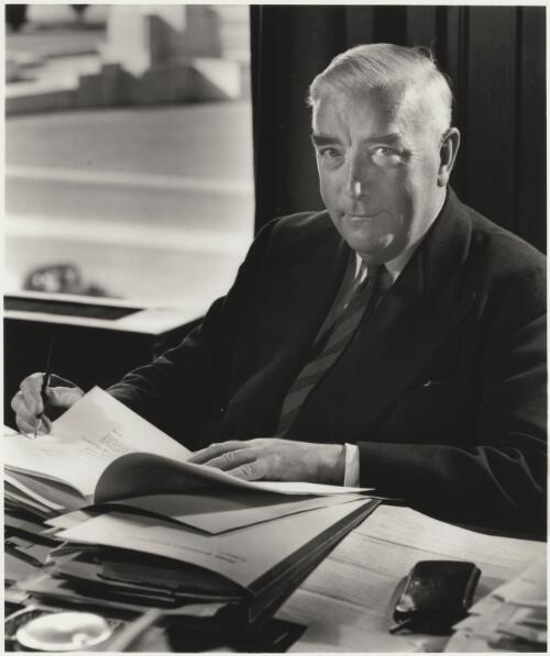 Sir Robert Menzies sitting at his desk signing papers, Parliament House, Canberra, ca. 1950 [picture] / Max Dupain