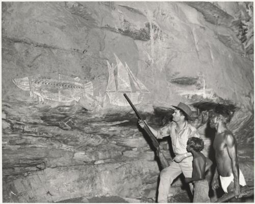 Allan Stewart with Old Nim and Roy the Boy in a cave at Nourlangie, Arnhem Land, in the Northern Territory, examining rock paintings, 1970 [picture] / Ern McQuillan