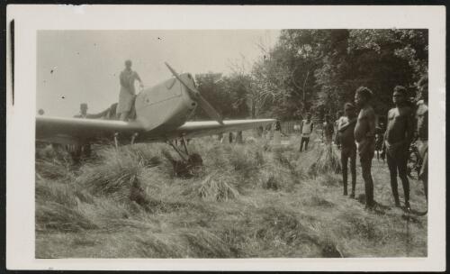 [Group of Aboriginal people standing around a grounded aeroplane] [picture] / H. J. Foster