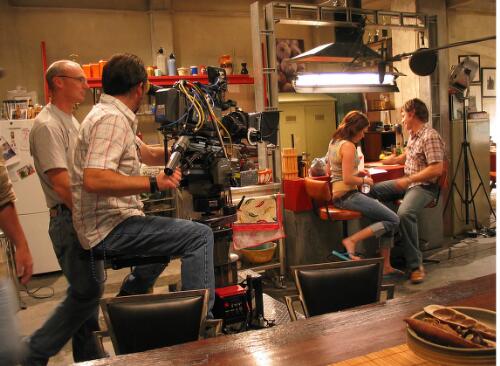 On the set of television series 'Last man standing' showing the crew and cast members, Jacinta Stapleton as Syl and Rodger Corser as Adam, rehearsing prior to shooting a scene, Central City Studios, Docklands, Melbourne, 14 February 2005 [picture] / June Orford