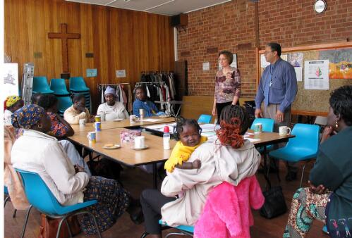 Jane Mabior, accompanied by nine month old daughter Adol, attends a weekly support group for Sudanese mothers seen here with guest speaker Fiona Turland, a mothercraft nurse who is assisted by interpreter Charles Bibawi, Melbourne, 2005 [picture] / June Orford