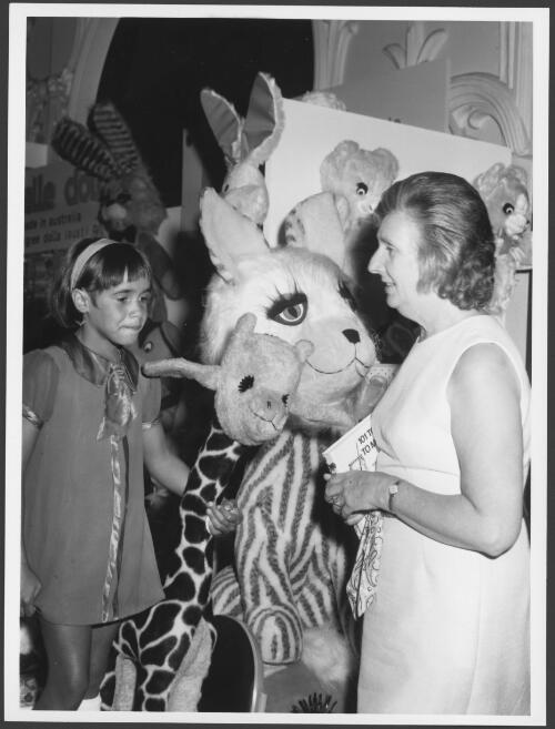 Mrs Margaret Whitlam, wife of the Prime Minister of Australia, with one of the small guests from the Marella Mission Home at the opening of the annual toy fair in Sydney in mid-March 1973 [picture] / Australian Information Service photograph by A. Osolins