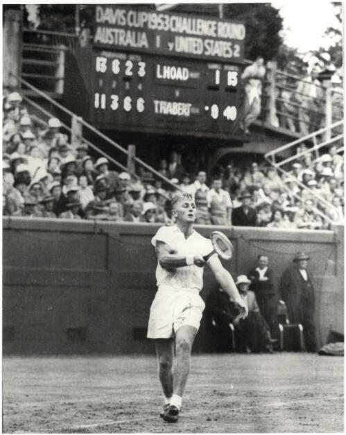 Lew Hoad wearing spike shoes, [playing Tony Trabert] at a wet Kooyong, when defeating the Americans in their 1953 Davis Cup Challenge [picture] / Ern McQuillan