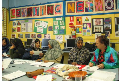 Class members, refugees from Afghanistan, Pakistan and the former Yugoslavia, practise English language exercises at the Fitzroy Learning Network, Fitzroy, Victoria, 2005 [picture] / June Orford
