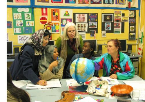 Helen, the tutor, centre, discusses points of interest with her students, refugees from Afghanistan, Pakistan, Ethiopia and the former Yugoslavia, at the Fitzroy Learning Network, Fitzroy, Victoria, 2005 [picture] / June Orford
