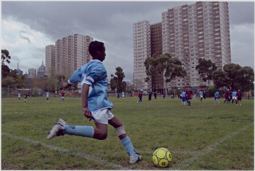 Flemington Eagles striker Osman, representing the Flemington high rise Housing Commission flats, lets fly with a corner cross, Atherton Reserve, Fitzroy, Victoria, September 10, 2005 [picture] / Dave Tacon