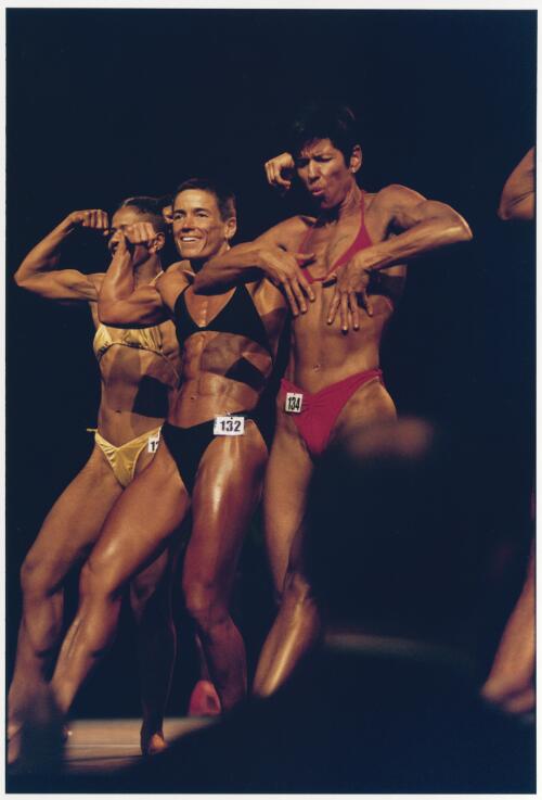 Three female body builders in a physique competition at the Sydney Gay Games, 2002 [picture] / C. Moore Hardy