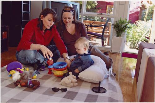 Natasha Biltoft-Spark and Erin Patterson playing with their ten month old son, Flynn, Fairfield, Victoria, 2005 [picture] / Dave Tacon