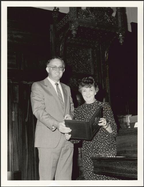 Speaker Joan Child and Deputy Speaker Leo McLeay, of the House of Representatives, [with House of Representatives Prayer book] [picture] / Australian Information Service
