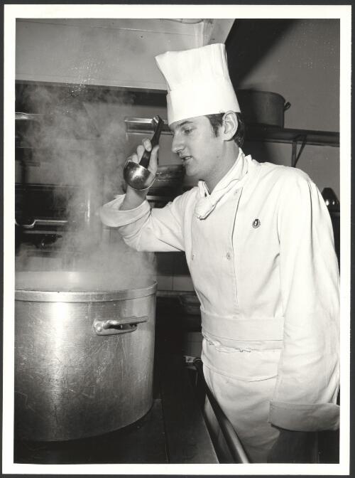 Barry Dignam, apprentice of the year for Victoria, 1976, examines stock simmering in the kitchen of  Le Chateau Restaurant in France [picture] / Australian Information Service photo by John McKinnon