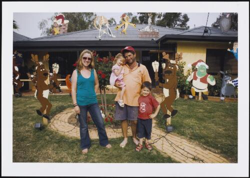 Family, left to right, Julie Moore (mother), Jamiesen Moore, Shane Moore (father) & Sebastian Moore in front of home decorated for Christmas, Numurkah, Victoria, 16 December 2005 [picture] / Michael Coyne