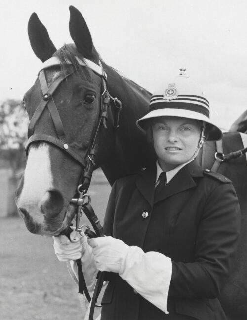 Constable Heather Crack, in her dress uniform, with her police horse Blue Tact, a former racehorse, Queensland, 1975 [picture] / Bob Nichol