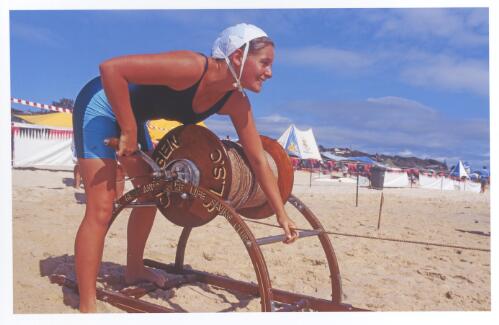 Cudgen Surf Life Saving Club female lifesaver trainee with reel, at a northern New South Wales beach carnival, ca. 1995 [picture] / Jeff Carter