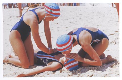 Resuscitation exam practical for female lifesaver trainees on the beach at a northern New South Wales beach carnival, ca. 1995 [picture] / Jeff Carter