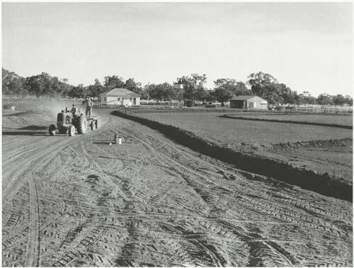 Farmers with a tractor on a soldier settlement farm, Murrumbidgee Irrigation Area, New South Wales, 1957 [picture] / Jeff Carter