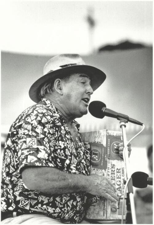 Ted Egan singing with a beer carton instrument, Kiama Folk Festival, New South Wales, ca. 1995 [picture] / Jeff Carter