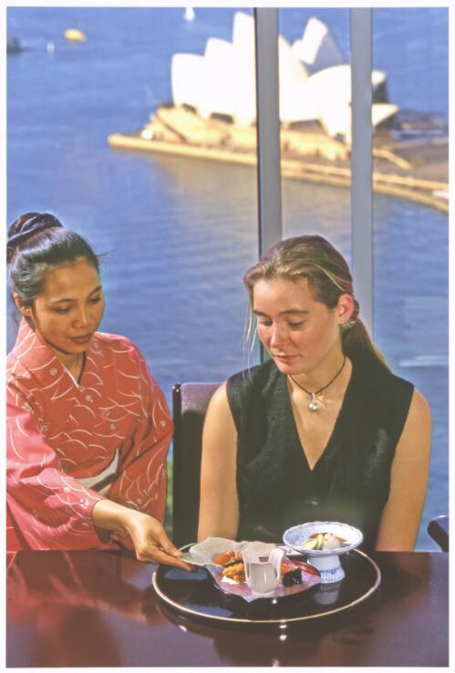 A waitress serving dried mullet roe or karasumi to a diner at the Unkai restaurant, ANA Hotel Sydney, 1993 [picture] / Jeff Carter
