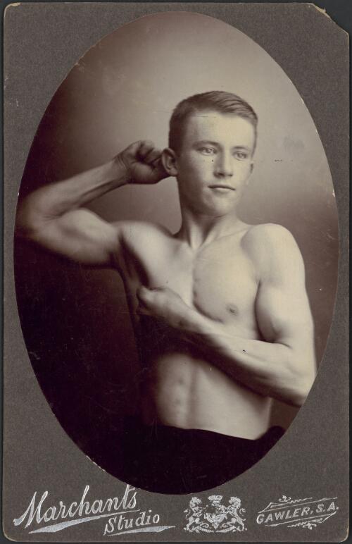Young Australian male athlete flexing his muscles, ca. 1899 [picture] / W.P. Marchant, Marchant's Studio
