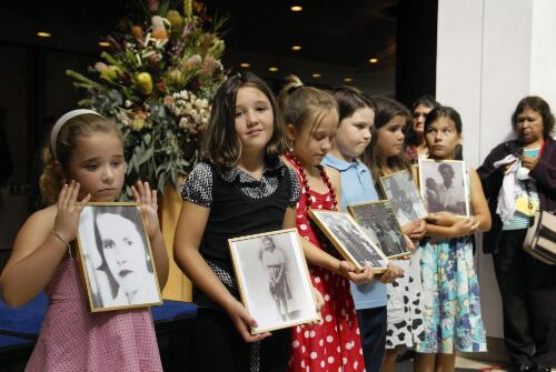 Children holding portraits of members of the stolen generation during the Apology to the Stolen Generations at Parliament House, Canberra, 13 February 2008 [picture] / Mervyn Bishop