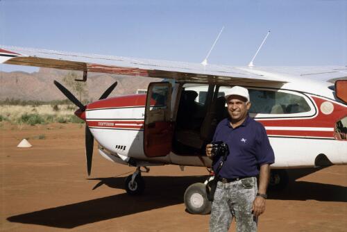 Photographer, Mervyn Bishop, standing beside a Cessna Centurion aircraft, Western Australia [picture] / Mervyn Bishop and David McRae