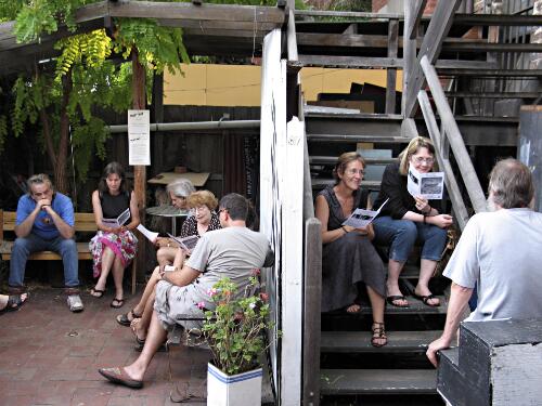Patrons sitting in the courtyard of La Mama Theatre, Carlton, Melbourne, February 2007 [picture] / Francis Reiss