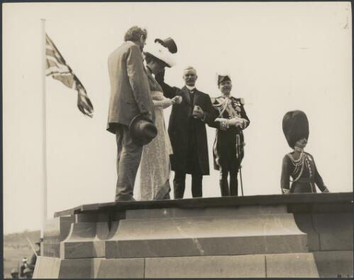 Andrew Fisher, Lord and Lady Denman and King O'Malley acknowledge the crowd from the foundation stone at the naming of Canberra ceremony, 12 March 1913 [picture]