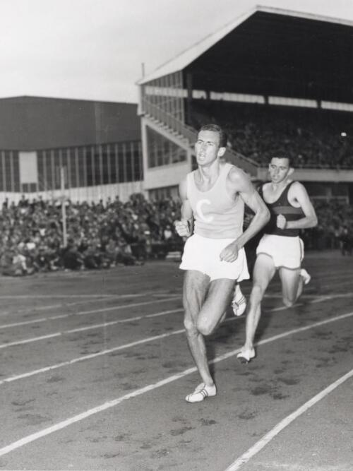 Herb Elliott leading Merv Lincoln during a race at Olympic Park, Melbourne, 20 January, 1958 [picture] / Australian News and Information Bureau