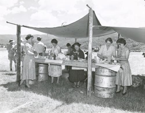 Farmer's wives preparing a meal at a picnic race meeting at Talbingo Station, Southern Highlands, New South Wales, 1956 [picture] / J. Fitzpatrick