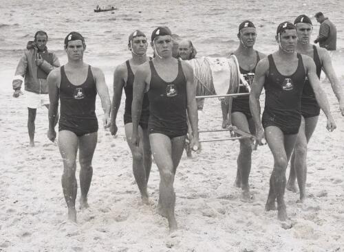 March past of members of a surf lifesaving club during a carnival, New South Wales, ca. 1960 [picture]