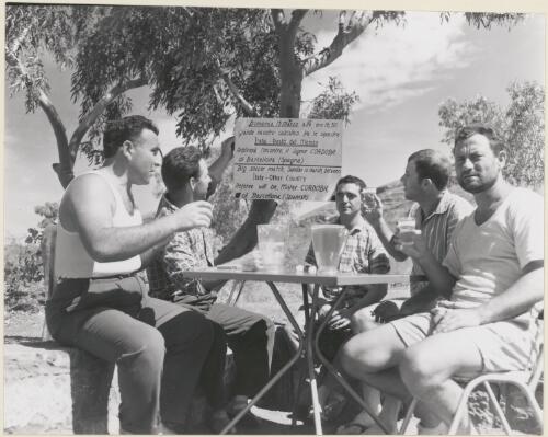 Workers at Mount Tom Price, John Cornio, Venice, Bob Sweeney, Scotland, Frank Cordoba, Madrid, Meotto Mario, Pardova Italy and Felice D'Antuoni, Sansero Italy drinking to the success of a Sunday afternoon soccer match which will take place on the red gravel soccer ground, March 1966 [picture]