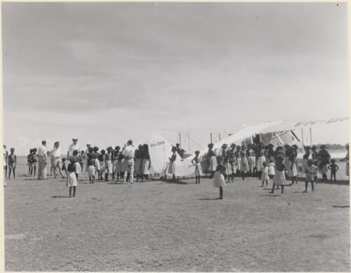 A crowd gathers around an aeroplane at the Roman Catholic mission at Bathurst Island, Northern Territory 1958 [picture]
