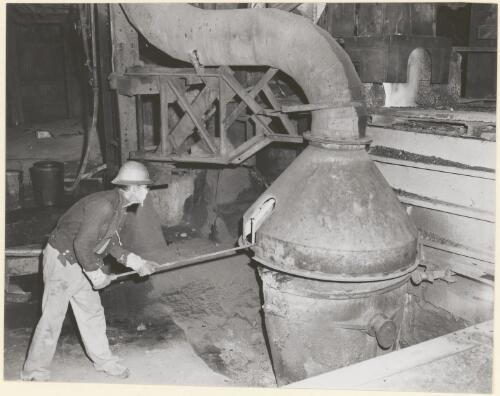 Stoking the furnace in the lead mill at Mount Isa, 1959 [picture]