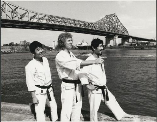 Tamio Tsuji, right, his brother Ryo and leading Queensland karate exponent Danny Ellaby, beside the Brisbane river with Story Bridge behind 1973 [picture]