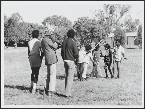 Jacky Kala Kala watches as Bamyili pupils practice the fish dance, Baymyili, Northern Territory, 1 November 1972 [picture] / by Michael Jensen