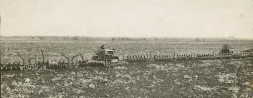 Two Thiess Bros. tractors pulling ten ploughs to turn the first sods of earth at Peak Downs, Queensland, 1948 [picture] / Thiess Bros. Pty Ltd