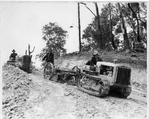 Stan Thiess operating a caterpillar tractor, Burleigh Hill roadworks, Queensland, 1936 [picture] / Thiess Bros. Pty Ltd