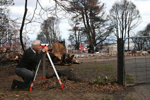 A man taking measurements to rebuild the Sparkes family home, following the February 2009 bushfires, Kinglake, Victoria, 17 April 2009 [picture] / June Orford