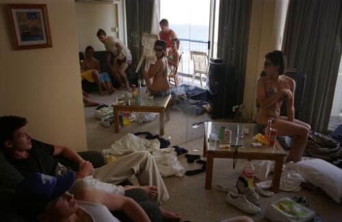 A group of school leavers inside their messy hotel room during Schoolies Week, Gold Coast, Queensland, November 2005 [picture] / James Brickwood