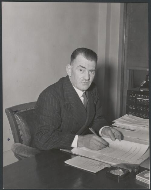 Portrait of John Johnstone Dedman at his desk, 1947? [picture]