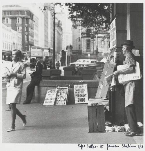Paper seller at the Elizabeth Street entrance to St. James Railway Station, Sydney, February 1966 [picture] / Ted Richards