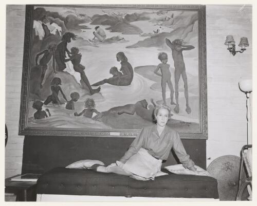 Portrait of Elizabeth Durack seated in front of her painting, War and Peace, 1961 [picture] / W. Hartley