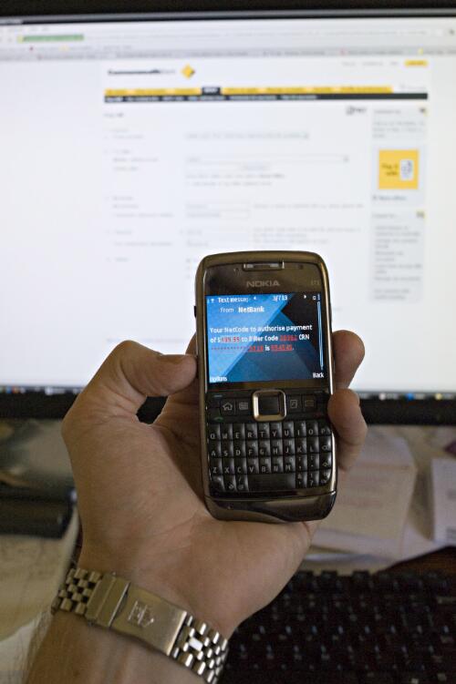 Photographer Dave Tacon receives a text message on his Nokia E71 mobile phone that contains a security code designed to verify a new biller from the Commonwealth Bank's NetBank, Melbourne, 19 January 2010 [picture] / Dave Tacon