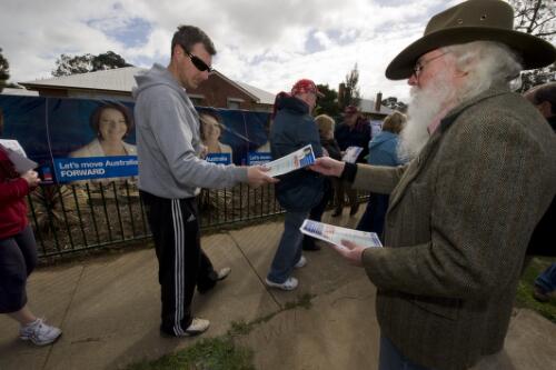 Voters accepting Labor party how to vote pamphlets at Werribee Public School in the Division of Lalor, during the Australian Federal Election, Melbourne, August 2010 [picture] / Benjamin Rushton