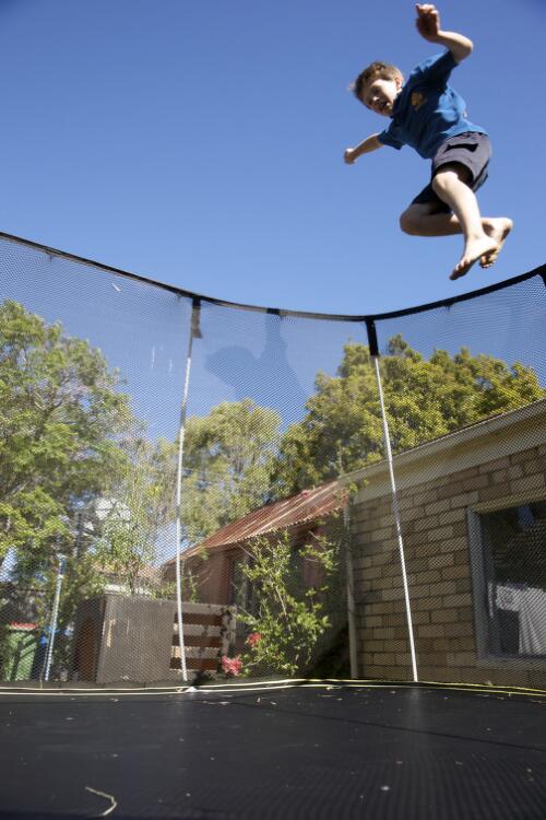 Archie Perkins jumping on a trampoline in his backyard, Sandringham, Melbourne, 2 March 2010 [picture] / Robin Smith