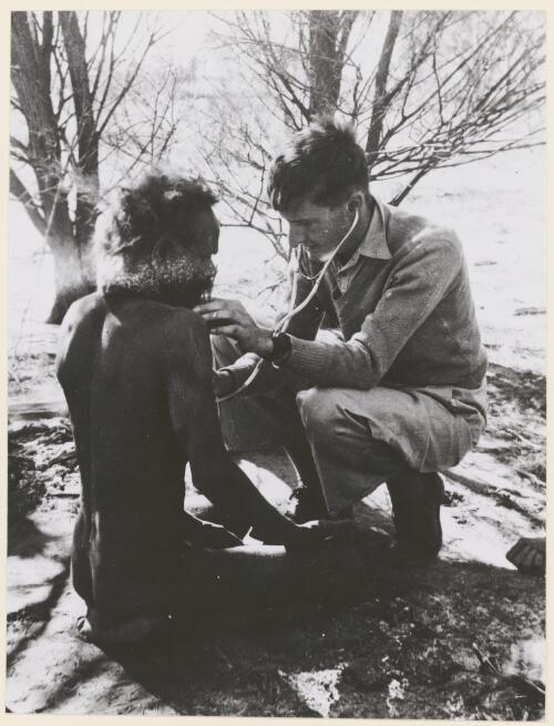 Dr. J. Hargrave of the Northern Territory Health Dept. examines a man from the Pintupi language group, Northern Territory, 1957, 1 [picture] / Australian News and Information Bureau