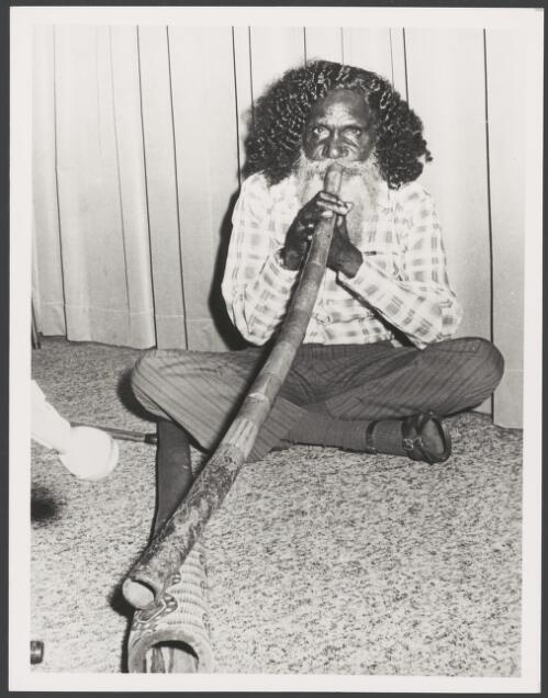 Wandjuk Marika of the Yirrkala Language group and member of the Aboriginal Arts Board of the Australia Council playing a didgeridoo, Arnhem Land, Northern Territory, 16 February 1976 [picture]