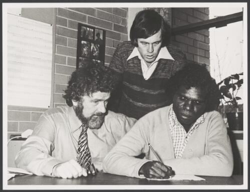 Ritharrngu man, Yilarama's first formal English language lesson, looking on are Dr. Neville White and Roger Hooke, Director, La Trobe University's Language Centre, Melbourne, 2 December 1982 [picture]